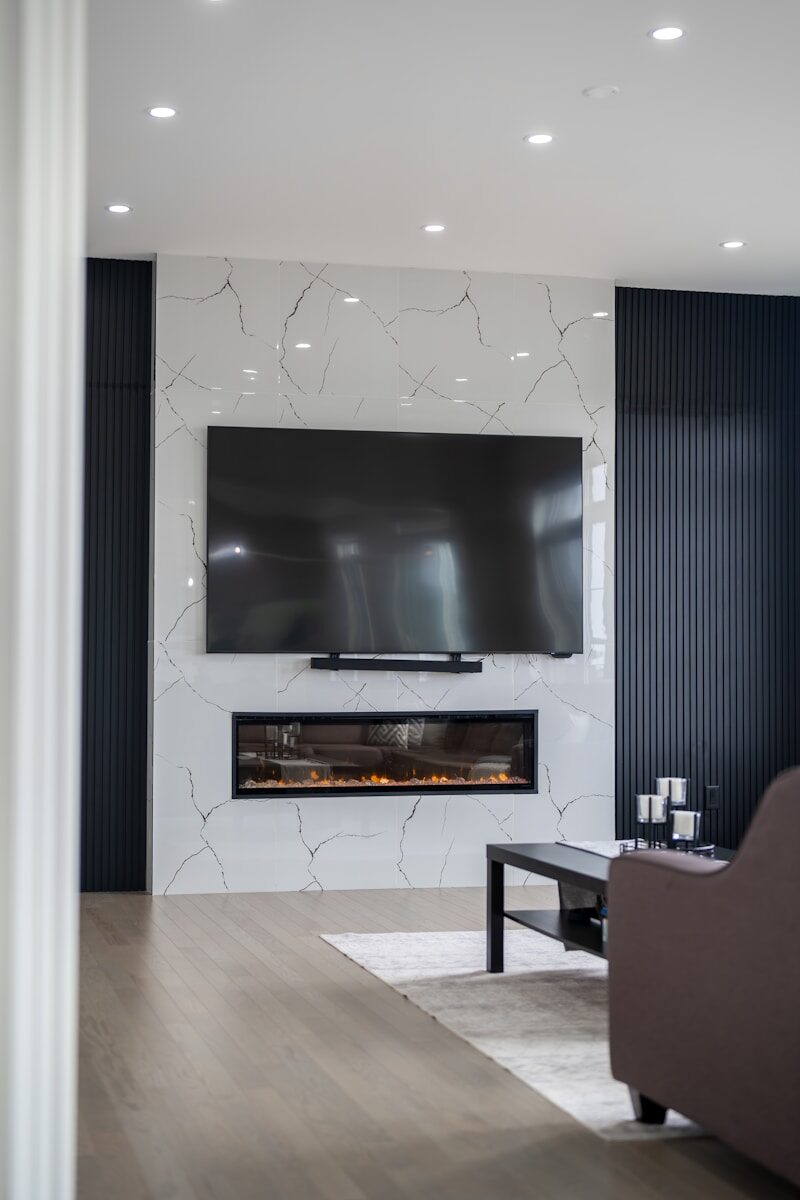 Modern living room with fireplace and large television.